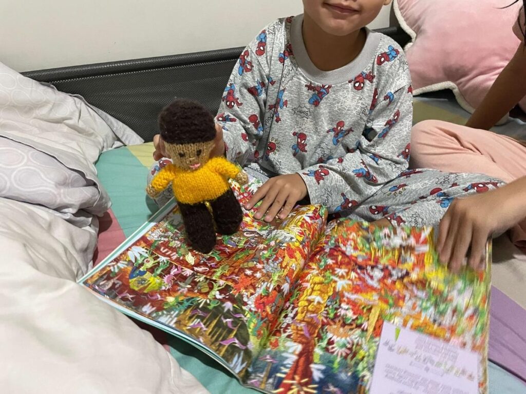 Boy using a toy to make reading fun