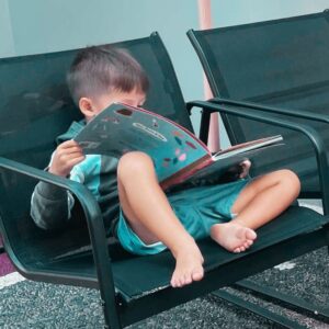 boy reading outside